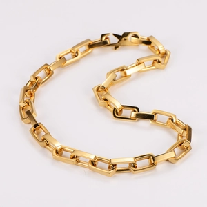 Detail of minimalist gold plated rectangular link chain necklace with high gloss finish