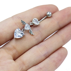 Detail of silver belly ring with heart zircon stones and angel wing design