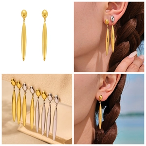 Detailed views of gold and silver teardrop earrings showing high polish finish and fit