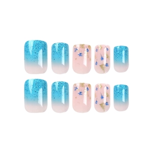 Blue gradient and floral press-on nails with golden glitter on white background