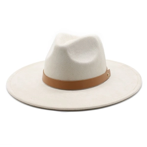 Detail showing beige felt fedora with brown leather strap and golden stud accents