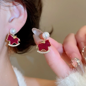 Detail of red rocking horse earrings with pearl accents and sparkling rhinestones