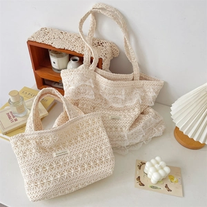 Detail of hollow floral crochet texture and delicate lace ruffles on cream tote bag