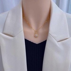 Elegant gold tulip pendant necklace with white mother-of-pearl and crystal accents