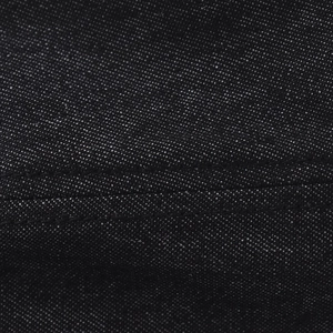 Macro shot of black denim fabric with white fiber specs and double stitching on hat