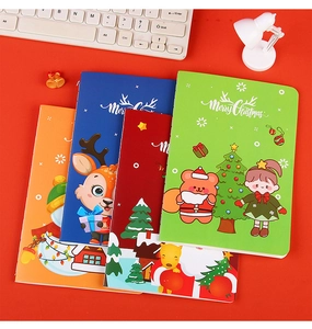 Set of four colorful Christmas A5 notebooks featuring cartoon Santas and reindeers