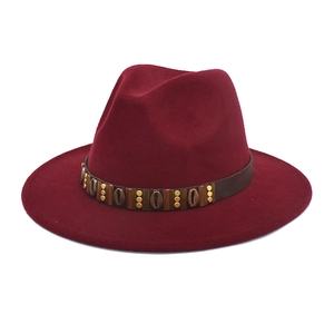 Close-up of deep wine red felt fedora featuring vintage bronze beads and metal ornaments
