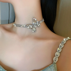 Close-up of sparkling rhinestone butterfly choker necklace on model's neck