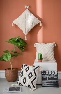 Detailed view of Moroccan style tufted throw pillows with geometric patterns and tassels