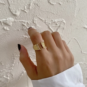Macro shot of gold-plated open ring featuring a unique irregular textured surface