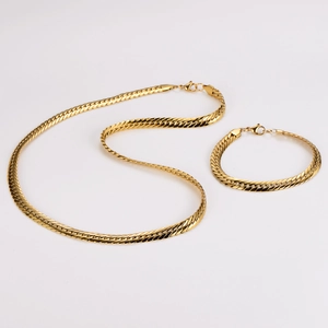 Detailed shot of 7.5mm flat dragon weave gold necklace and bracelet set with lobster clasp