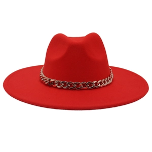 Detail of red wool felt fedora featuring a thick gold acrylic chain and wide brim