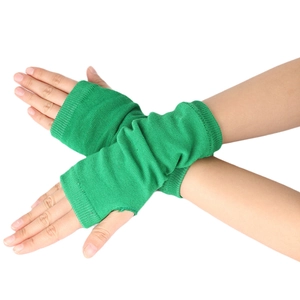 Close-up of bright green knitted fingerless gloves with ribbed texture on model hands