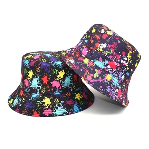 Tie-dye graffiti bucket hat for travel featuring colorful paint splatter on black fabric