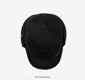 Top view of a black winter trapper hat featuring warm faux sheepskin lining and ear flaps