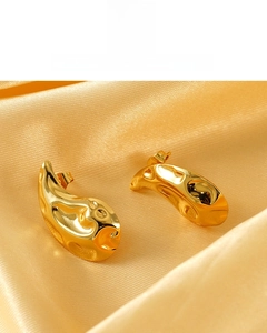 Detailed macro of 18K gold plated teardrop studs featuring a hammered lava texture