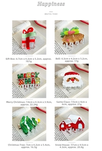 Close-up of glittery acrylic Christmas hair claws including Santa, tree and bell designs