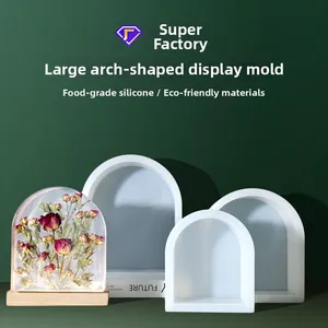 Macro detail of large arch silicone mold with finished floral resin craft and wooden base
