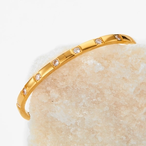 Elegant gold stainless steel geometric bracelet with seven zircon stones on white crystals