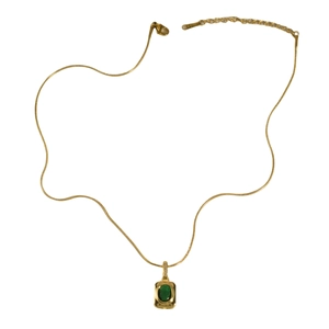 Elegant gold necklace with emerald green oval gemstone and diamond bezel setting