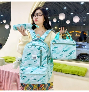 Mint green camo 3-piece backpack set including lunch bag and pencil case on model