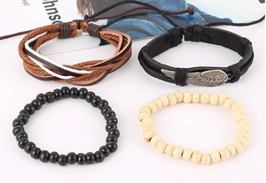 Detailed view of 4-piece vintage woven bracelet set with leather, wing charm and wood beads