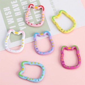Close-up of cat-shaped alloy spring rings in six colors for DIY keychain making