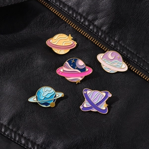 Detail of five-piece enamel space pins pinned on a premium black leather jacket