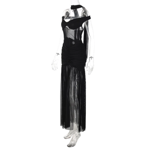 Detailed close-up of mesh sheer patchwork and ruched waist on a sexy black halter dress