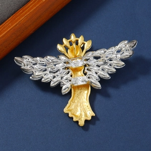 Vintage matte gold angel brooch with silver wings and crystals on dark blue background