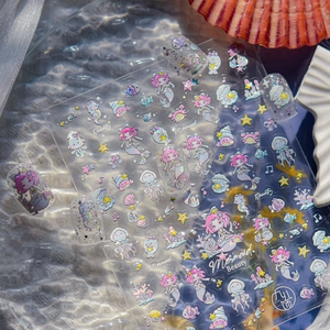 Holographic mermaid and sea shell nail art stickers shown on natural nails and packaging