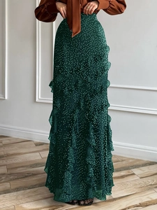 Green long skirt with white polka dots and layered ruffle details for casual wear