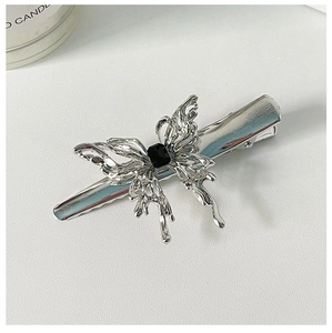 Detail of silver liquid metal butterfly hair clip with a black rectangular gemstone