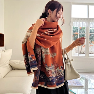 Detail of thick orange cashmere-feel scarf featuring artistic Chinese landscape painting