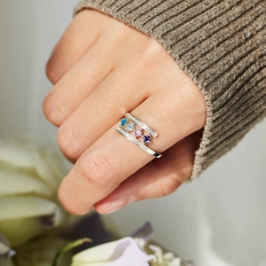 Close-up of S925 silver ring featuring four colored square zircons and pavé diamonds