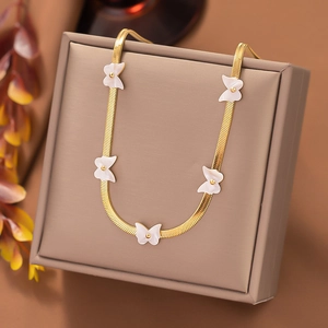 Detail of a gold snake chain necklace featuring five elegant white butterfly charms