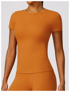 Close-up of terracotta slim-fit yoga t-shirt showing matte texture and double-stitched hem