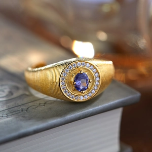 Macro shot of S925 silver tanzanite ring with blue stone and brushed gold finish