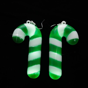 Macro shot of glowing green and white striped LED Christmas candy cane earrings
