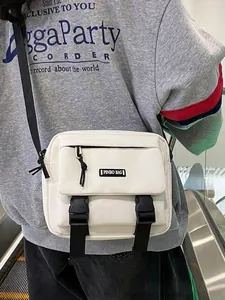 White canvas crossbody messenger bag with dual black buckle closure and adjustable strap