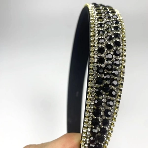 Detailed close-up showing Five-row rhinestones on the wide black headband surface