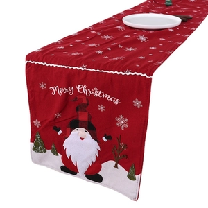 Knitted red Christmas table runner with Santa, snowflakes, and Merry Christmas text