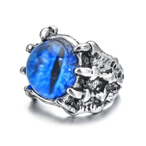 Close-up of punk dragon claw ring in silver finish with a realistic blue demon eye stone