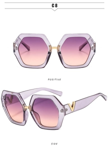 Detail of oversized hexagonal sunglasses with gradient lenses and gold metal V-logo