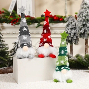Three glowing Christmas gnomes with snowflake knitted hats and star toppers on steps