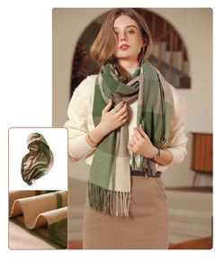 Detail of green and beige plaid cashmere scarf showing soft texture and fringe tassels