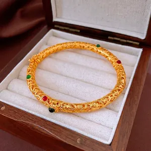 Vintage 24K gold plated openwork cuff bracelet with ruby and emerald style gems