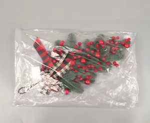 Close-up of Christmas teardrop swag with pine branches and red berries in OPP bag