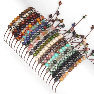 Detail of adjustable woven bracelets with colorful 4mm stone beads on display