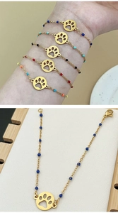 Detail of bohemian gold beaded bracelets with colorful beads and dog paw pendants